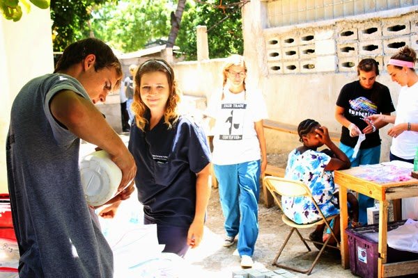A volunteer with children at a community clinic